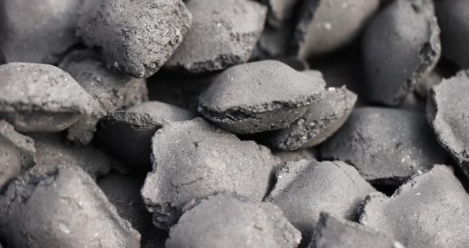 charcoal from crumbs is obtained under pressure and used to light a fire and cook food on the grill, black charcoal in briquettes for barbecues and grills