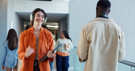 Happy woman, greeting and listening with headphones to music for work energy in office hallway. Creative, female person or group with high five for positive attitude or company vibe in workplace