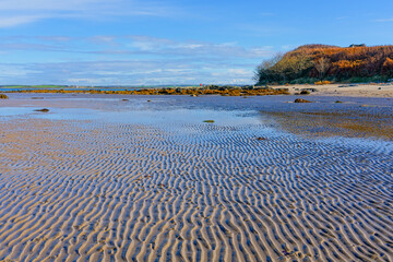 Autumn day on Penrhos beach, Anglesey, at low tide.