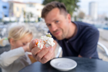 Girl Eating Ice Cream with Her Dad at a Cafe