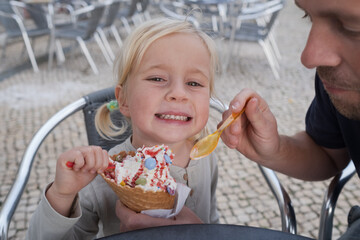 Girl Eating Ice Cream with Her Dad at a Cafe