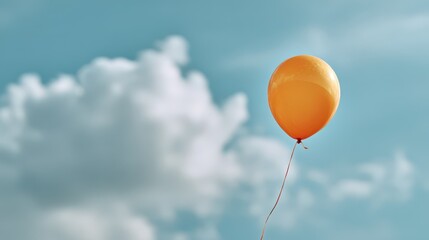 Orange balloon floating gracefully in the blue sky with large white clouds, expressing freedom, happiness, and lightness in a bright and airy outdoor atmosphere on a sunny day