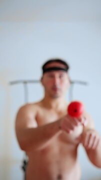 Boxer training with a fightball, male engaging in tether ball exercises with a ball on an elastic band, utilizing tether ball for reflex development combined with mindfulness and boxing practices.