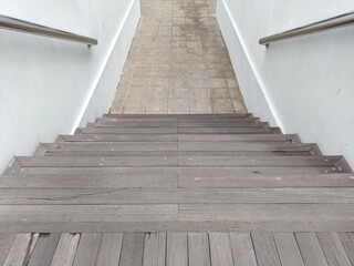 Weathered Wooden Staircase Leading Down to a Tiled Floor