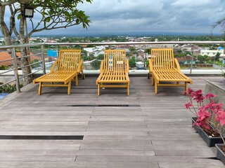 Rooftop Deck with Wooden Lounge Chairs and City View