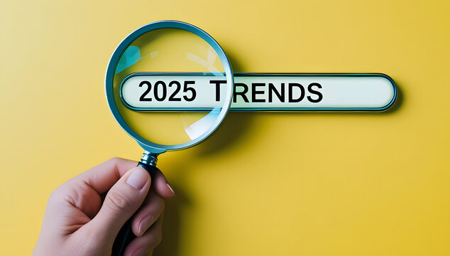Magnifying glass searching for current 'trends' on a vibrant yellow background