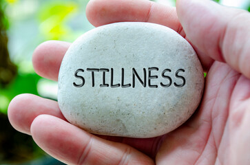Stillness text engraved on white stone. Life harmony concept.