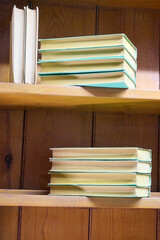 Old vintage books on wooden shelves