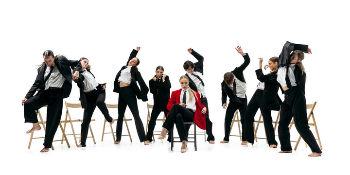 Business team performing expressive synchronized poses around confident leader in red coat. Concept of corporate identity, leadership structure, teamwork alignment and modern business culture.