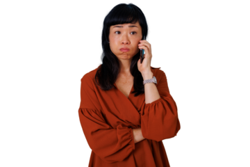 Upset asian woman pouting during bad news phone call, experiencing disappointment, sadness, and worry