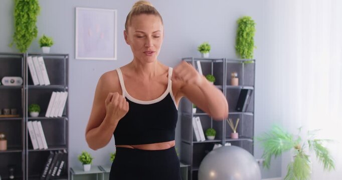 Young active fit sporty yogi fighter woman wearing sportswear boxing, combat sport and martial art, strength training technical exercise to boost fitness, burn fat, relieve stress, build confidence