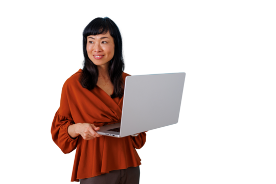 Asian businesswoman smiling, holding a laptop, standing for modern corporate work, technology, connectivity, and communication