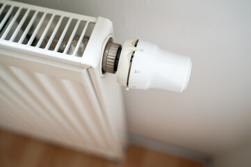 Closeup of radiator power regulator in apartment turned to lowest setting showing heating fully off