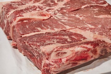 A raw chuck steak, also called a stewing steak