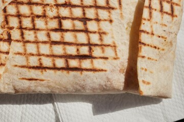 A French Tacos, a popular European fast food, filled with chicken and cheese