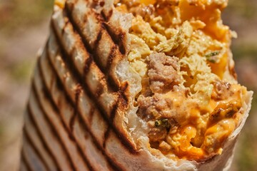 A French Tacos, a popular European fast food, filled with chicken and cheese