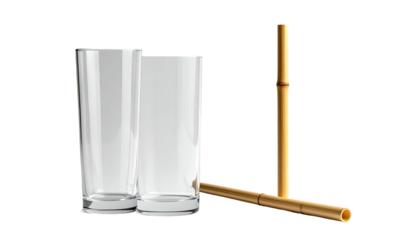 Two glass tumblers and a decorative bamboo element against a black backdrop