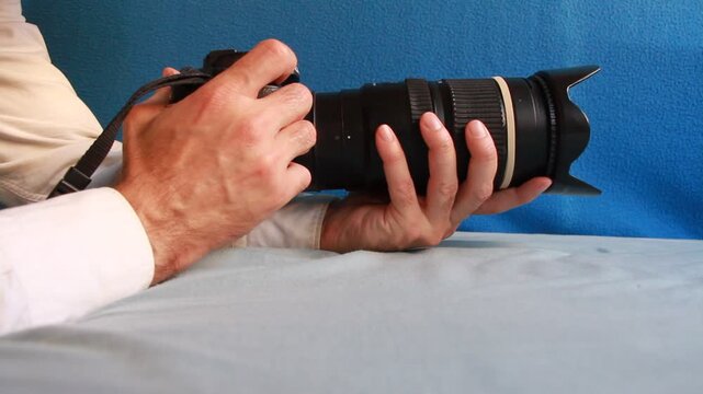 Disparando y apretando el obturador de una cámara de fotos con teleobjetivo en modo ráfaga y velocidad de obturación alta