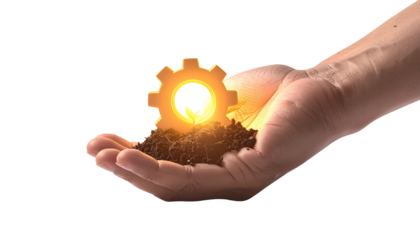 A hand, with soil, cradles a glowing gear against a black background