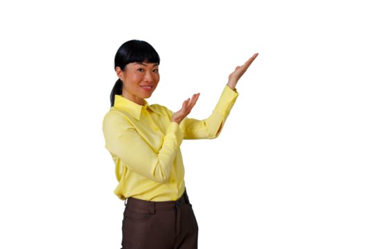 Woman in yellow shirt presenting and introducing a concept with open hands gesture and friendly smile