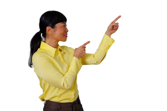 Asian businesswoman in yellow shirt pointing up and forward, showing direction, making a presentation, giving instruction, transparent background