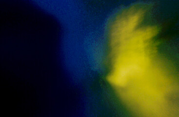 Dark abstract grainy background with deep blue and bright yellow light streaks texture