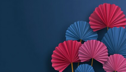 Naklejka premium Artistic Fan Display: An exquisite collection of vibrant paper fans arranged in a dynamic composition, featuring bold hues of red, pink, and blue against a deep blue backdrop.