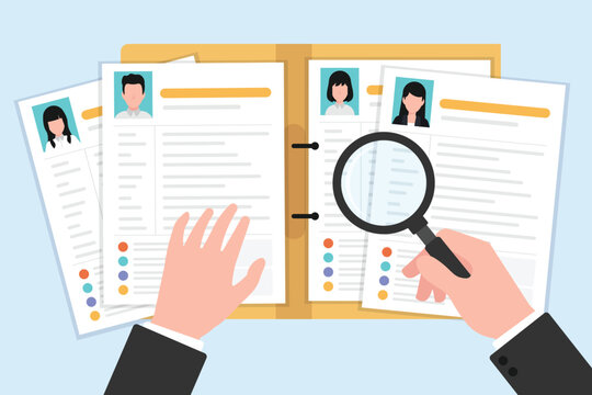 Hand holding a magnifying glass examining multiple resume or CV documents.