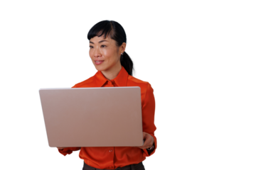 Asian businesswoman holding a laptop, working on technology and business projects with a friendly expression