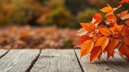 Wooden table with autumn orange leaves in a rustic seasonal composition.