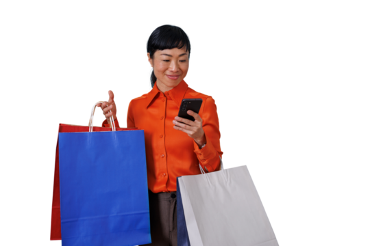 Asian woman online shopping using smartphone, holding many colorful retail paper bags, transparent background