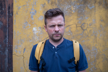 Portrait of a European Man by a Wall