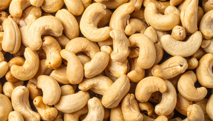 A close-up of raw cashew nuts, showcasing their natural shape and texture.