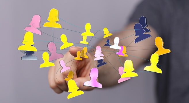 Hand touching digital connection graphic of multiple people, representing teamwork, communication, and global networking.