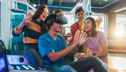 A group of diverse friends having fun, cheering a man wearing a VR headset in a futuristic game center, showcasing immersive gaming.