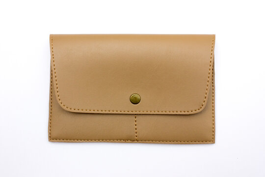 Beige leather clutch purse with snap button closure, isolated on white background.