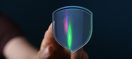 Hand holding a futuristic digital shield, symbolizing data protection, cybersecurity, and online...