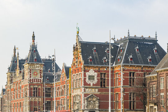 A beautiful red brick train station in Amsterdam, the Netherlands. This photo was taken on a cloudy winter day