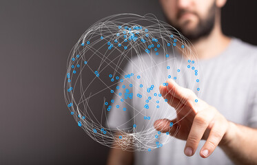A close up shot of a man pointing to a 3D digital globe representing the global network, technology and connection. Illustrative imag