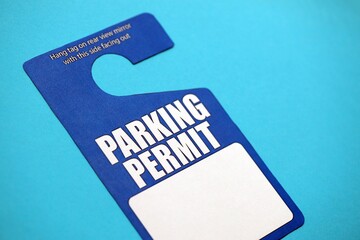 Parking permit paper notice tag for car interior close up. Parking permit for people with disabilities concept. Vip private parking