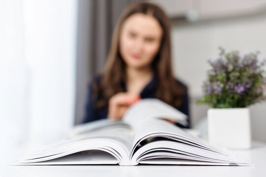 Close up of open paper book. Woman is reading books, opened two books on the table for studying and searching for information - Powered by Adobe