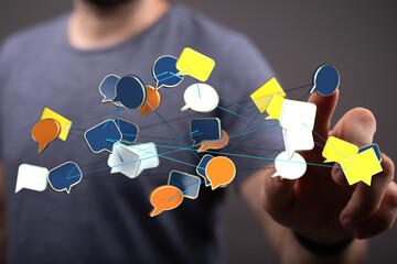 Person interacting with network of chat bubbles representing social media, networking, and digital communicatio