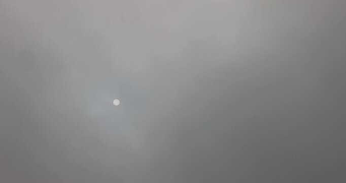 autumn sky covered with thick clouds and thick fog that slowly dissipates from sunlight, dreary gray sky and thick fog that obscures the view