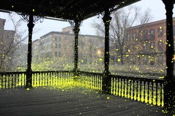 Pavilion interior with glowing lights and urban buildings in background.