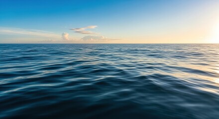 Open Ocean Horizon at Sunset with Calm Waves and Blue Sky