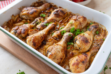 Oven baked chicken drumsticks with braised cabbage in a  casserole dish fresh and homemade cooked