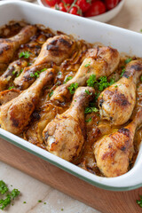 Oven baked chicken drumsticks with braised cabbage in a  casserole dish fresh and homemade cooked