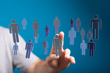 Hand reaching towards a collection of digital people icons, symbolizing connection, networking, and community.