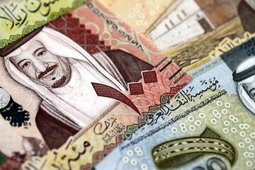 Saudi Arabia riyal money bills banknotes lies in big pile on table close up. Concept of finances...