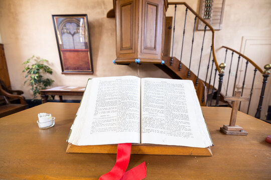 Parfondeval, Vervins, Aisne, Hauts-de-France, Grand-Est, France, August, 28th, 2025, Sacred scripture reading, Historic church with reverent sermon scene, Sunlit biblical manuscript on pulpit in